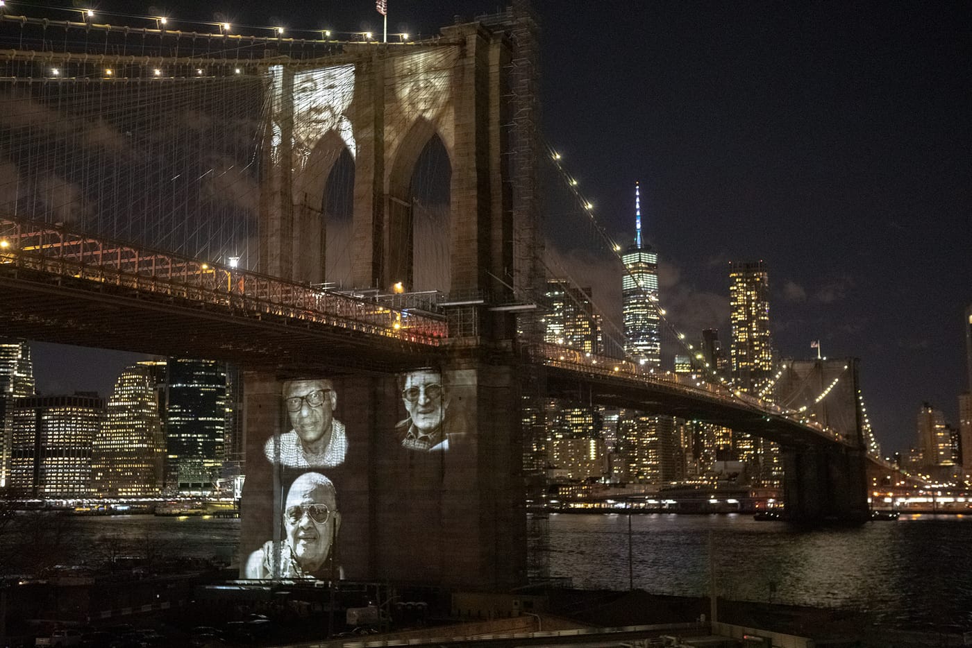 Behind the scenes on the Brooklyn Bridge — the portraits projected on the granite tower through the night of the ceremony.