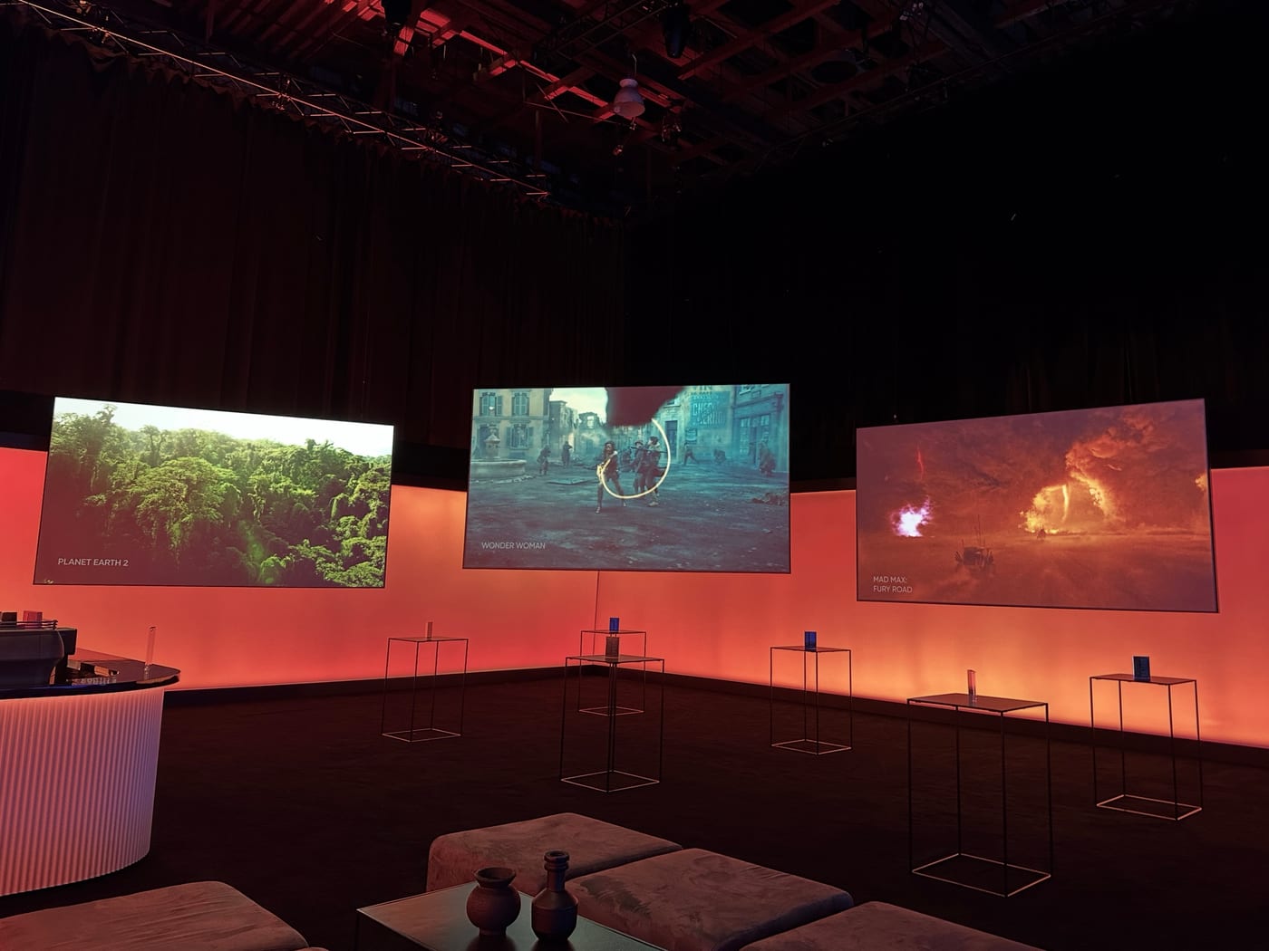 A dark launch environment ringed with red-lit landscape screens.