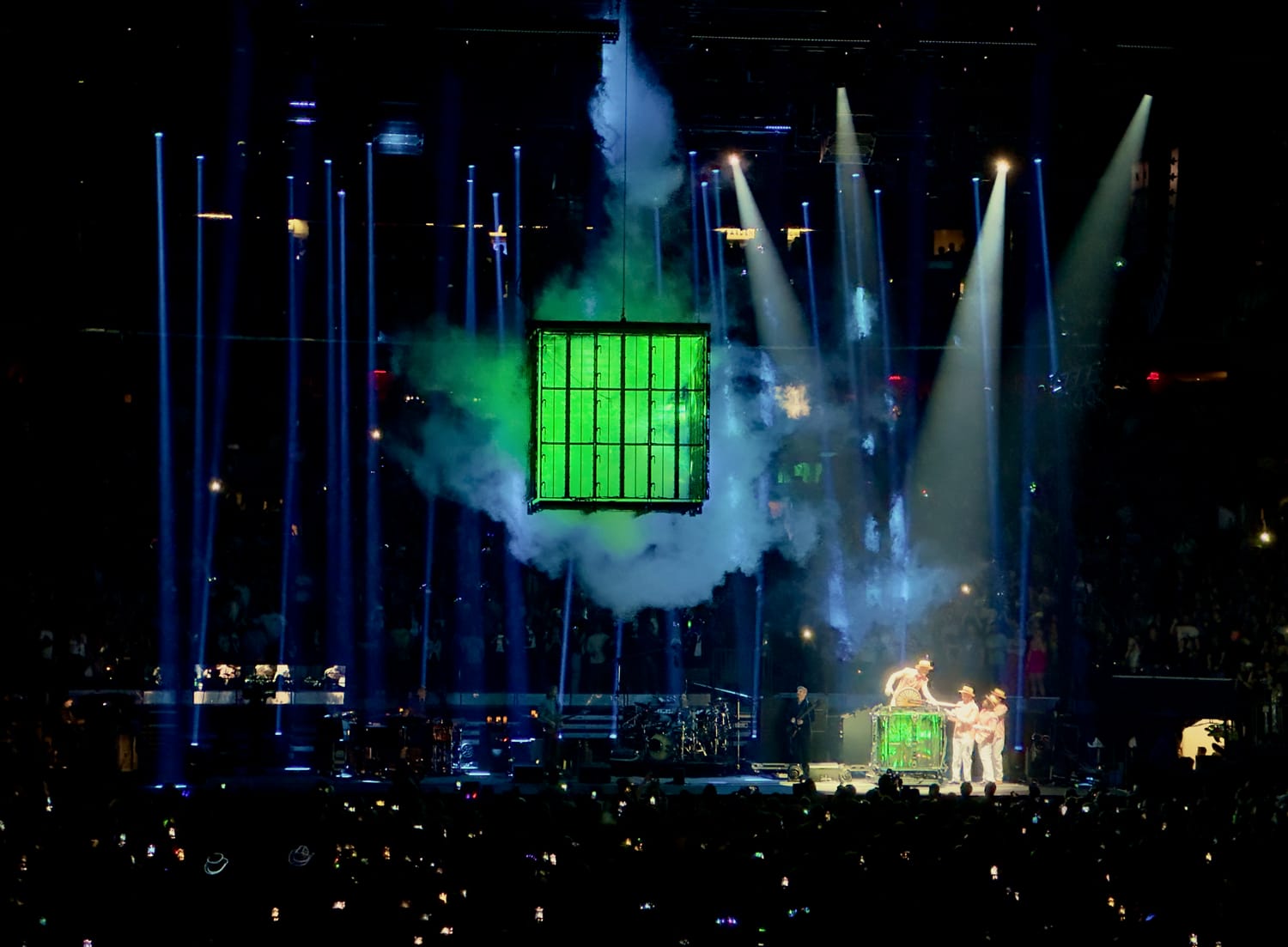 The time-machine cube glowing green in a cloud of smoke over the Phish stage, blue beams radiating across Madison Square Garden.